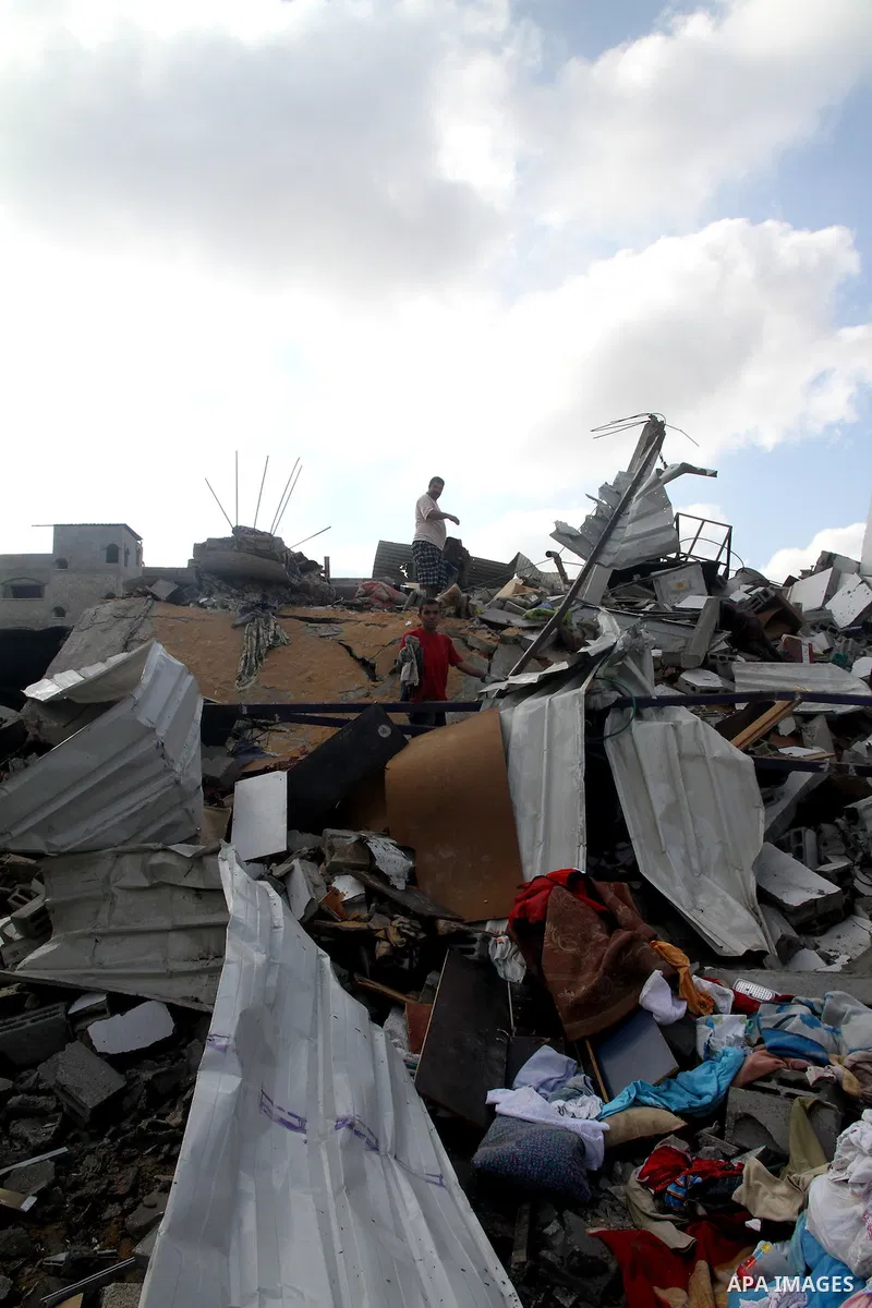Palestinians search for their belongings amid the remains of their house, which witnesses said was destroyed in an Israeli air strike, in Gaza City August 23, 2014. Hamas-led gunmen in Gaza executed 18 Palestinians accus...