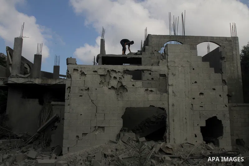 Palestinians search for their belongings amid the remains of their house, which witnesses said was destroyed in an Israeli air strike, in Gaza City August 23, 2014. Hamas-led gunmen in Gaza executed 18 Palestinians accus...