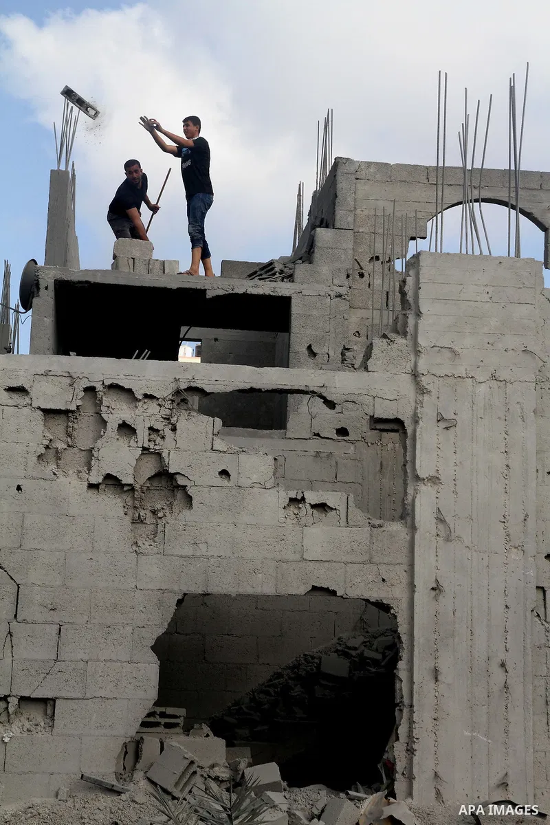 Palestinians search for their belongings amid the remains of their house, which witnesses said was destroyed in an Israeli air strike, in Gaza City August 23, 2014. Hamas-led gunmen in Gaza executed 18 Palestinians accus...