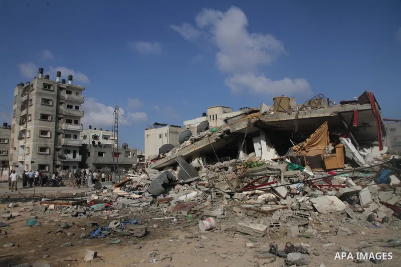 Palestinians search for their belongings amid the remains of their house, which witnesses said was destroyed in an Israeli air strike, in Gaza City August 23, 2014. Hamas-led gunmen in Gaza executed 18 Palestinians accus...