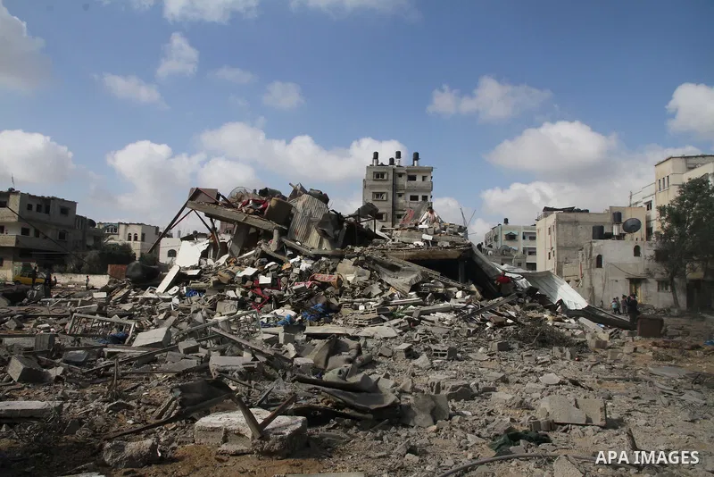 Palestinians search for their belongings amid the remains of their house, which witnesses said was destroyed in an Israeli air strike, in Gaza City August 23, 2014. Hamas-led gunmen in Gaza executed 18 Palestinians accus...