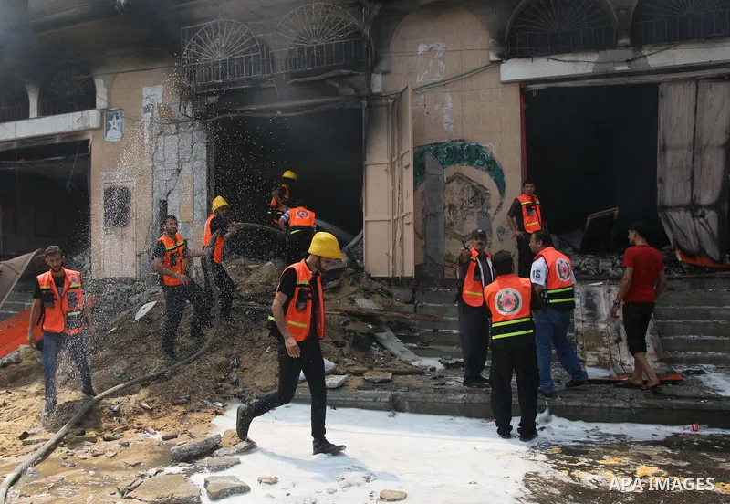 Palestinian firefighters participate in efforts to put out a fire at the scene of what witnesses said was an Israeli air strike on a house in Gaza City August 23, 2014. Israeli aircraft bombed the Gaza Strip on Saturday...
