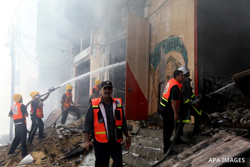 Palestinian firefighters participate in efforts to put out a fire at the scene of what witnesses said was an Israeli air strike on a house in Gaza City August 23, 2014. Israeli aircraft bombed the Gaza Strip on Saturday...
