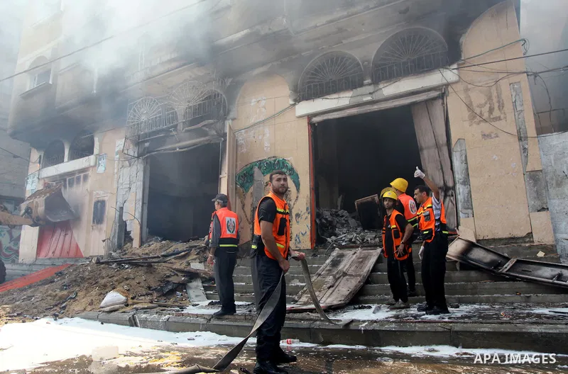 Palestinian firefighters participate in efforts to put out a fire at the scene of what witnesses said was an Israeli air strike on a house in Gaza City August 23, 2014. Israeli aircraft bombed the Gaza Strip on Saturday...