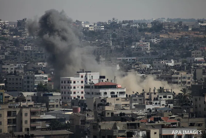 Smoke rises following an Israeli air strike on a Palestinian home in Gaza City on August 23, 2014. Israel kept up the pressure on Hamas in Gaza, carrying out multiple air strikes that killed six Palestinians, five of the...