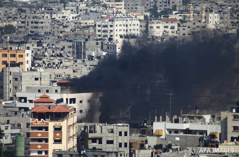 Smoke rises following an Israeli air strike on a Palestinian home in Gaza City on August 23, 2014. Israel kept up the pressure on Hamas in Gaza, carrying out multiple air strikes that killed six Palestinians, five of the...