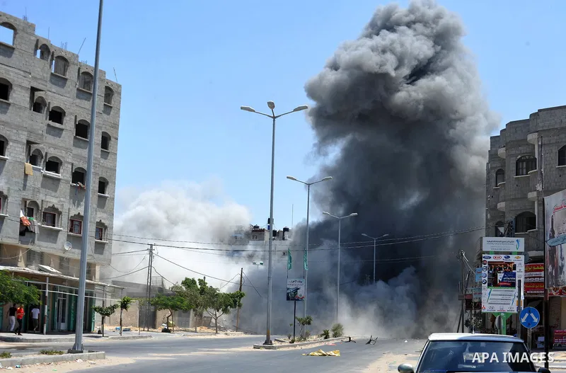 Smoke rises during what witnesses said was an explosion caused by an Israeli air strike on a house in Gaza City August 23, 2014. Israeli aircraft bombed the Gaza Strip on Saturday. Photo by Ezz Zanoun