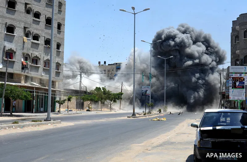 Smoke rises during what witnesses said was an explosion caused by an Israeli air strike on a house in Gaza City August 23, 2014. Israeli aircraft bombed the Gaza Strip on Saturday. Photo by Ezz Zanoun