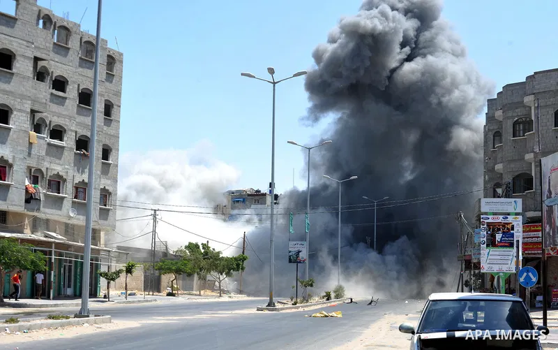 Smoke rises during what witnesses said was an explosion caused by an Israeli air strike on a house in Gaza City August 23, 2014. Israeli aircraft bombed the Gaza Strip on Saturday. Photo by Ezz Zanoun