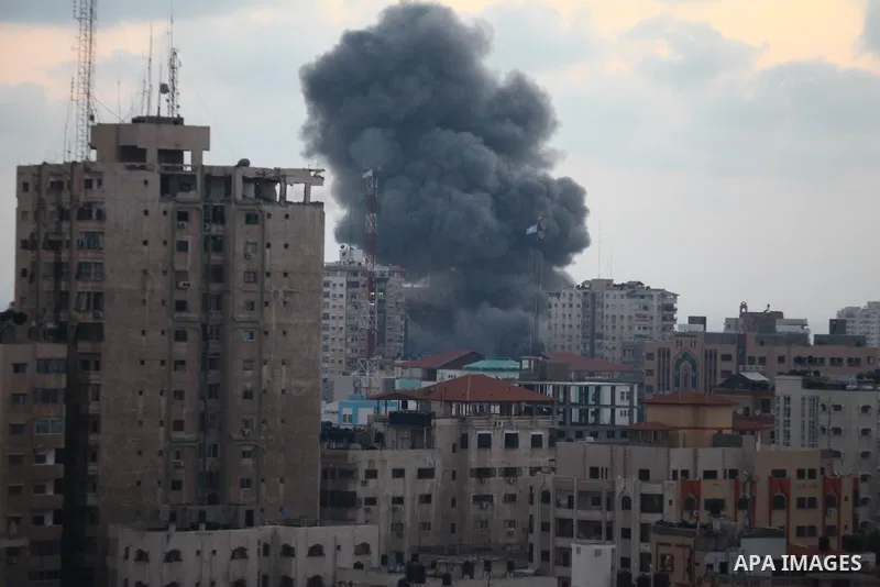 An apartment building (C) collapses just after it was hit by missiles during an Israeli air strike on the heart of Gaza City on August 23, 2014, wounding at least 18 people, four of them children. Residents in the 11-sto...