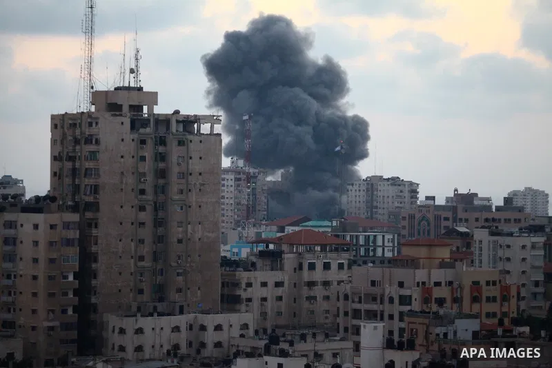 An apartment building (C) collapses just after it was hit by missiles during an Israeli air strike on the heart of Gaza City on August 23, 2014, wounding at least 18 people, four of them children. Residents in the 11-sto...