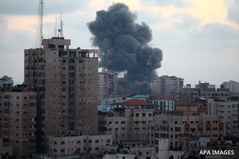 An apartment building (C) collapses just after it was hit by missiles during an Israeli air strike on the heart of Gaza City on August 23, 2014, wounding at least 18 people, four of them children. Residents in the 11-sto...