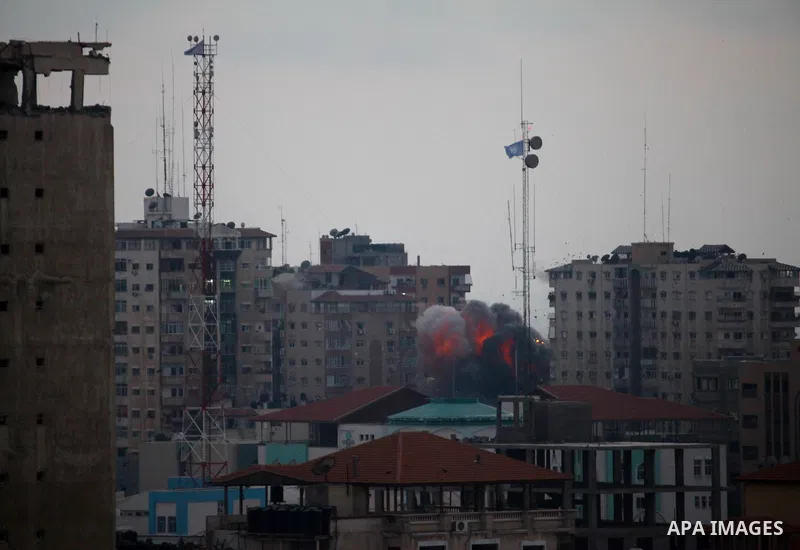 A ball of fire rises from an explosion on al-Zafer apartment tower following an Israeli air strike in Gaza City, in the northern Gaza Strip, Saturday, Aug. 23, 2014. Israeli aircraft fired two missiles at a 12-story apar...