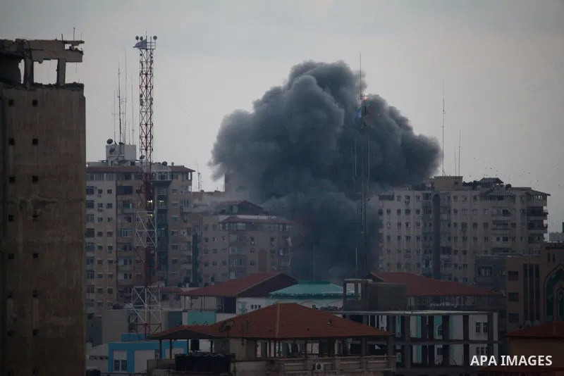 An apartment building (C) collapses just after it was hit by missiles during an Israeli air strike on the heart of Gaza City on August 23, 2014, wounding at least 18 people, four of them children. Residents in the 11-sto...