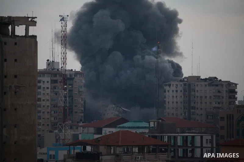 An apartment building (C) collapses just after it was hit by missiles during an Israeli air strike on the heart of Gaza City on August 23, 2014, wounding at least 18 people, four of them children. Residents in the 11-sto...