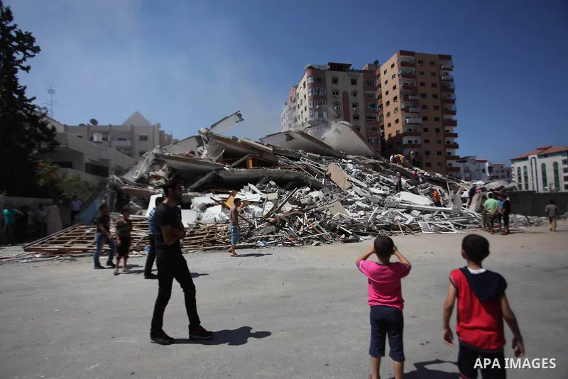 Palestinians look at the rubble of a residential tower, which witnesses said was destroyed in an Israeli air strike, in Gaza City August 24, 2014. Egypt called on Israel and the Palestinians on Saturday to halt hostiliti...