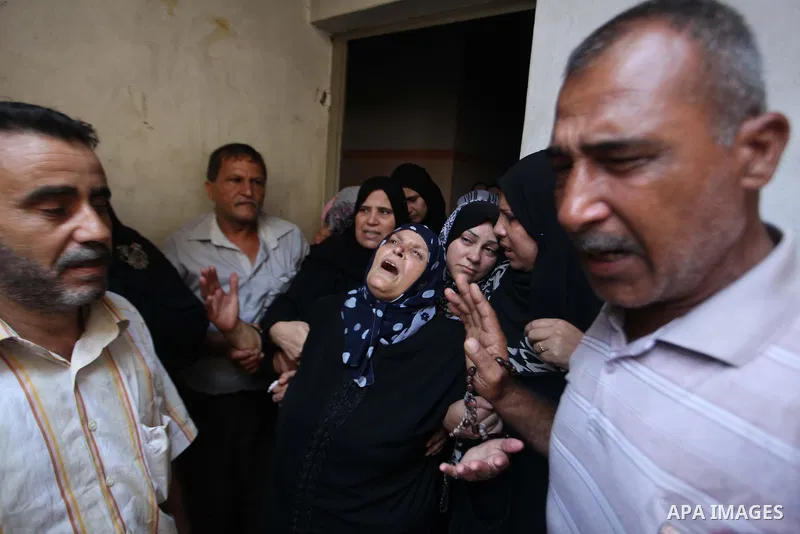 Relatives of Palestinian Mahmud Abbas, who was killed by an Israeli air strike, mourn during his funeral in Gaza City on August 24, 2014. An Israeli air strike killed two Palestinians in Gaza as militants kept up rocket...