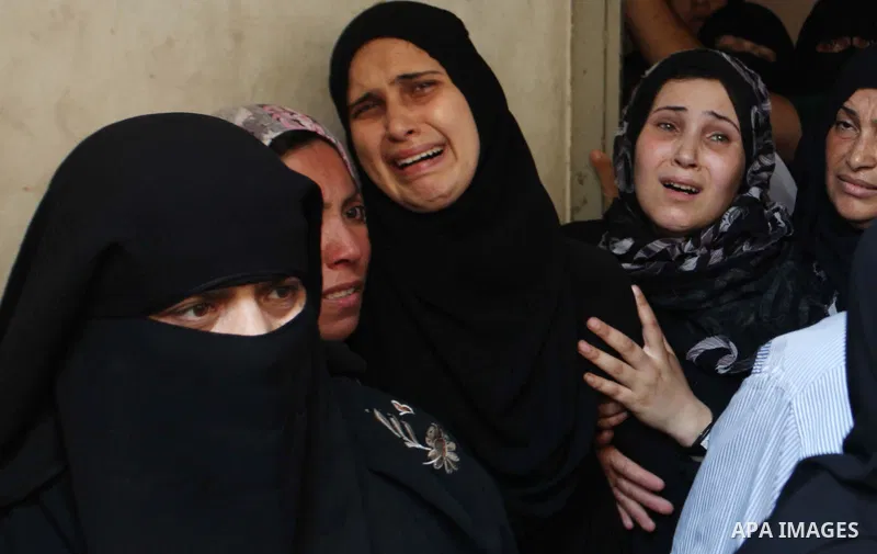 Relatives of Palestinian Mahmud Abbas, who was killed by an Israeli air strike, mourn during his funeral in Gaza City on August 24, 2014. An Israeli air strike killed two Palestinians in Gaza as militants kept up rocket...