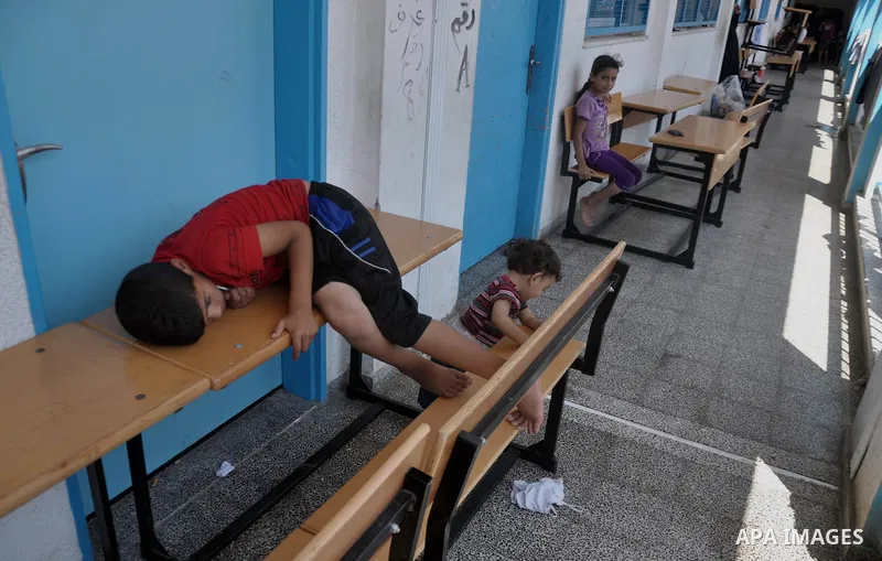 Palestinian displaced children sit at a UN school in Gaza City on August 24, 2014. The UN recently said that 460,000 Palestinians have been displaced by the violence which is more than a quarter of the population of the...