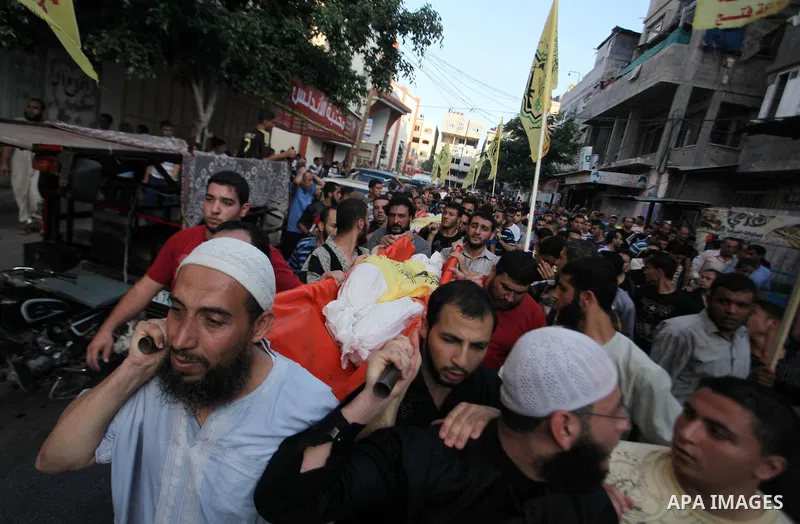 Mourners carry the body of one of four Palestinians from the Juda family, whom medics said were killed in an Israeli air strike, during their funeral in Jabaliya in the northern Gaza Strip August 24, 2014. Israeli Prime...