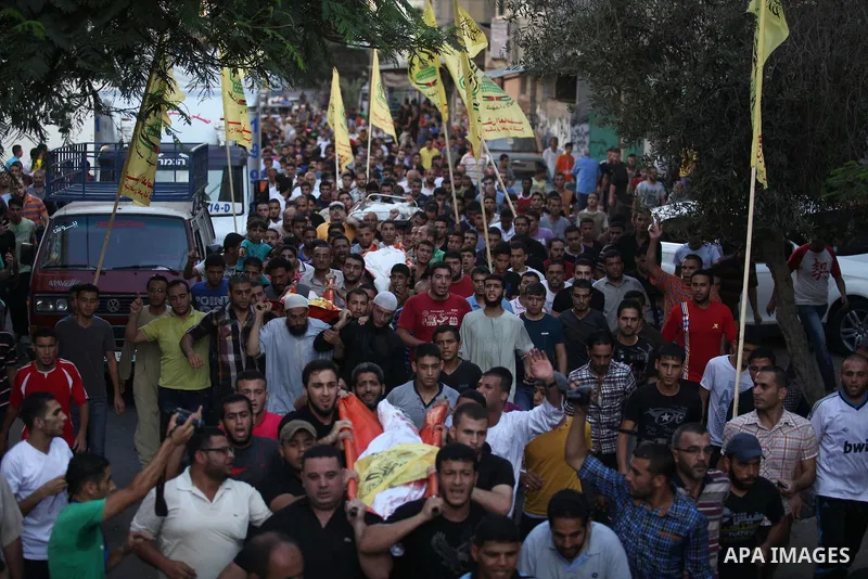 Mourners carry the body of one of four Palestinians from the Juda family, whom medics said were killed in an Israeli air strike, during their funeral in Jabaliya in the northern Gaza Strip August 24, 2014. Israeli Prime...