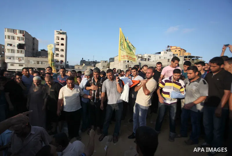 Mourners carry the body of one of four Palestinians from the Juda family, whom medics said were killed in an Israeli air strike, during their funeral in Jabaliya in the northern Gaza Strip August 24, 2014. Israeli Prime...