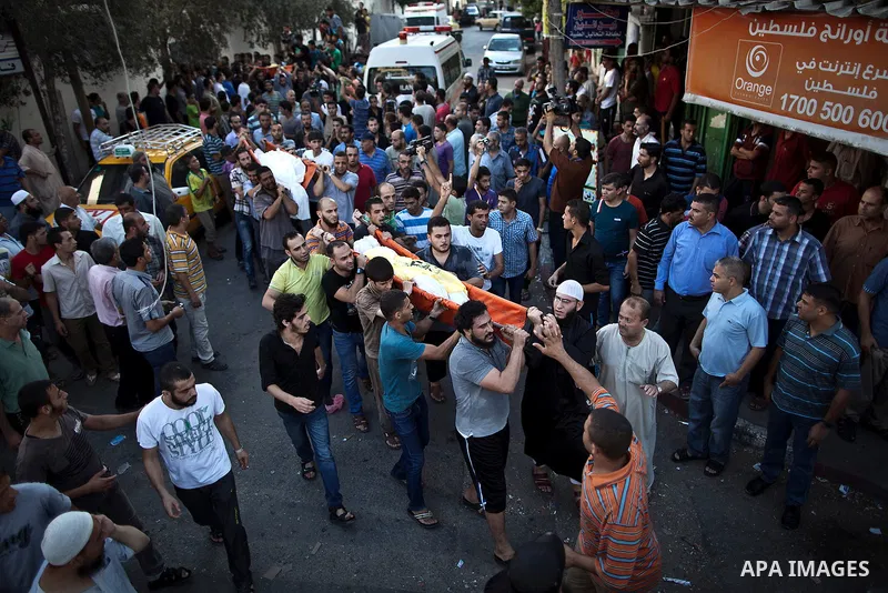Mourners carry the body of one of four Palestinians from the Juda family, whom medics said were killed in an Israeli air strike, during their funeral in Jabaliya in the northern Gaza Strip August 24, 2014. Israeli Prime...