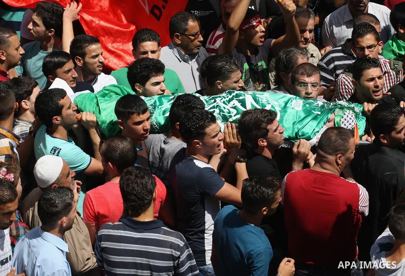 Palestinians carry the body of Hassan Ashour, a Palestinian teenager who died of his injuries, during his funeral on August 25, 2014 in the West Bank city of Nablus. Hassan Ashur was shot in the abdomen with live fire as...