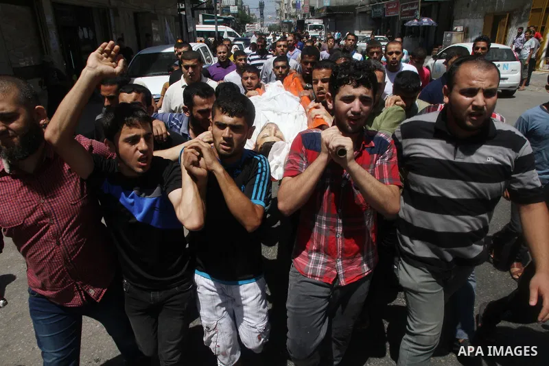 Mourners carry the body of of Palestinian Osama Shabbir, whom medics said was killed in an Israeli air strike, during his funeral in Jabaliya in the northern Gaza Strip August 25, 2014. Israel's Prime Minister Benjamin N...