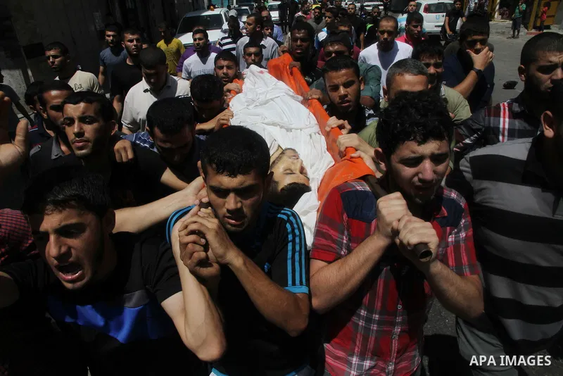 Mourners carry the body of of Palestinian Osama Shabbir, whom medics said was killed in an Israeli air strike, during his funeral in Jabaliya in the northern Gaza Strip August 25, 2014. Israel's Prime Minister Benjamin N...