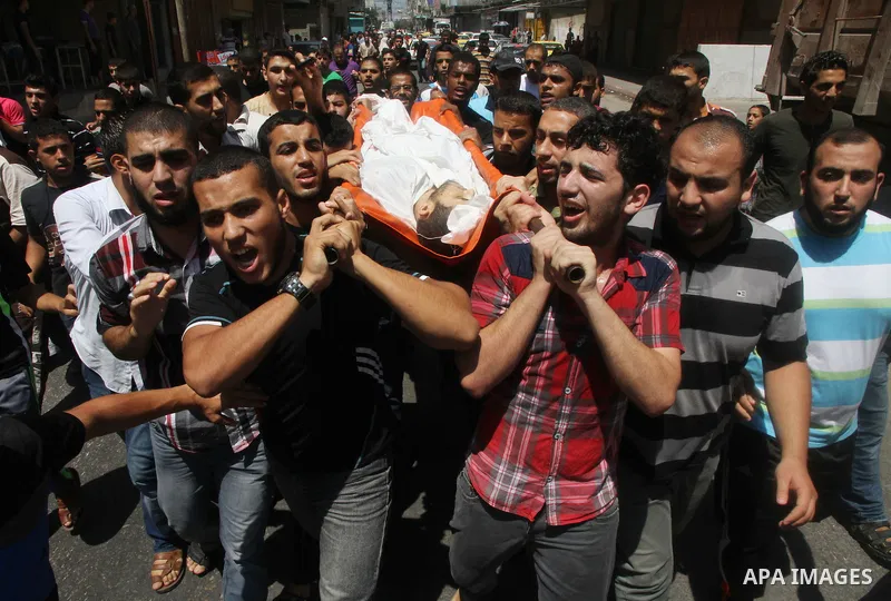 Mourners carry the body of of Palestinian Osama Shabbir, whom medics said was killed in an Israeli air strike, during his funeral in Jabaliya in the northern Gaza Strip August 25, 2014. Israel's Prime Minister Benjamin N...