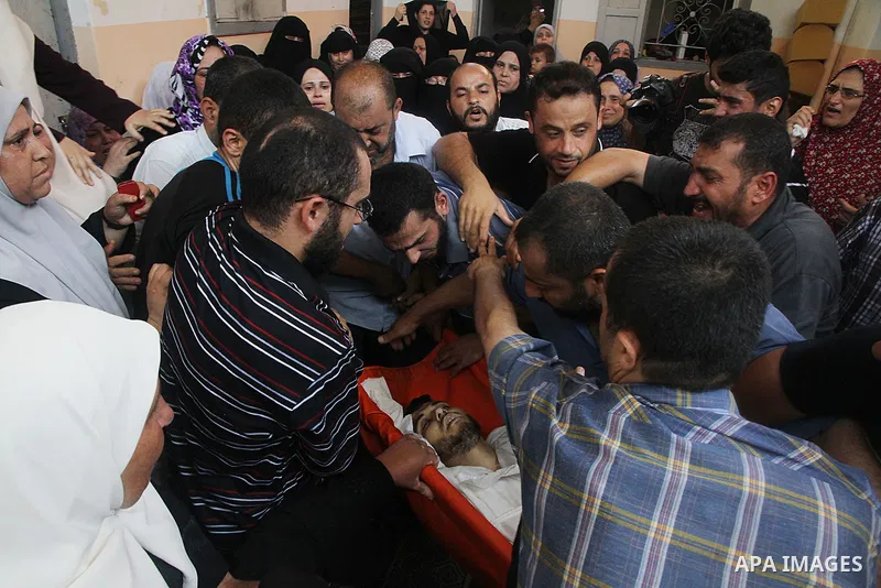 Mourners carry the body of of Palestinian Osama Shabbir, whom medics said was killed in an Israeli air strike, during his funeral in Jabaliya in the northern Gaza Strip August 25, 2014. Israel's Prime Minister Benjamin N...