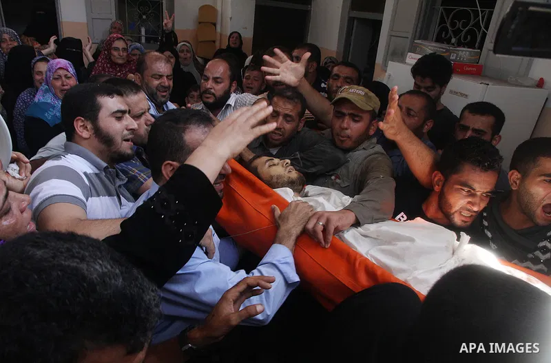 Mourners carry the body of of Palestinian Osama Shabbir, whom medics said was killed in an Israeli air strike, during his funeral in Jabaliya in the northern Gaza Strip August 25, 2014. Israel's Prime Minister Benjamin N...