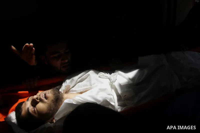 Mourners carry the body of of Palestinian man, whom medics said was killed in an Israeli air strike, during his funeral in Jabaliya in the northern Gaza Strip August 25, 2014. Israel's Prime Minister Benjamin Netanyahu w...