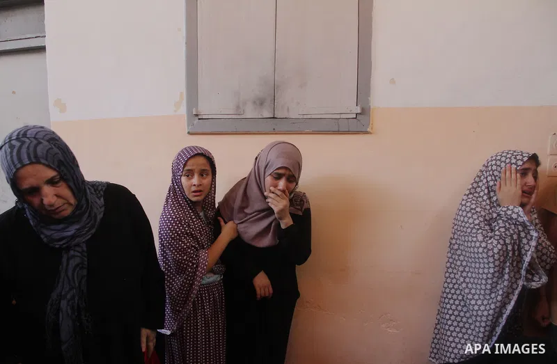 Palestinian relatives mourn on the body of of Palestinian Osama Shabbir, whom medics said was killed in an Israeli air strike, during his funeral in Jabaliya in the northern Gaza Strip August 25, 2014. Israel's Prime Min...