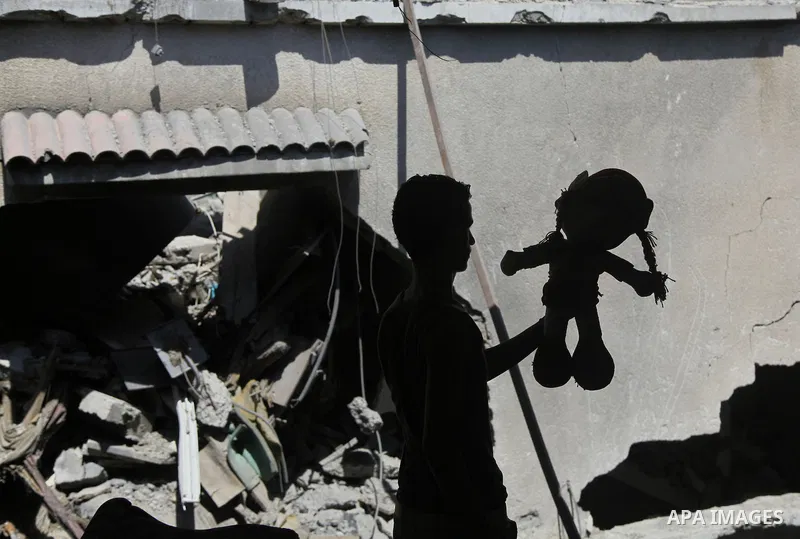 A Palestinian man inspects a house targeted in an Israeli air strike in Gaza city on August 25, 2014. Israel's Prime Minister Benjamin Netanyahu warned Palestinian civilians on Sunday to leave immediately any site where...