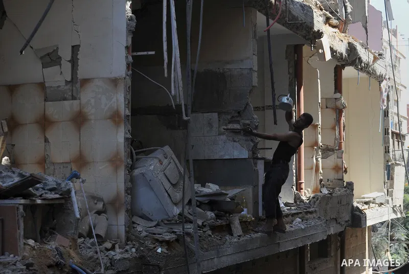 A Palestinian man inspects a house targeted in an Israeli air strike in Gaza city on August 25, 2014. Israel's Prime Minister Benjamin Netanyahu warned Palestinian civilians on Sunday to leave immediately any site where...