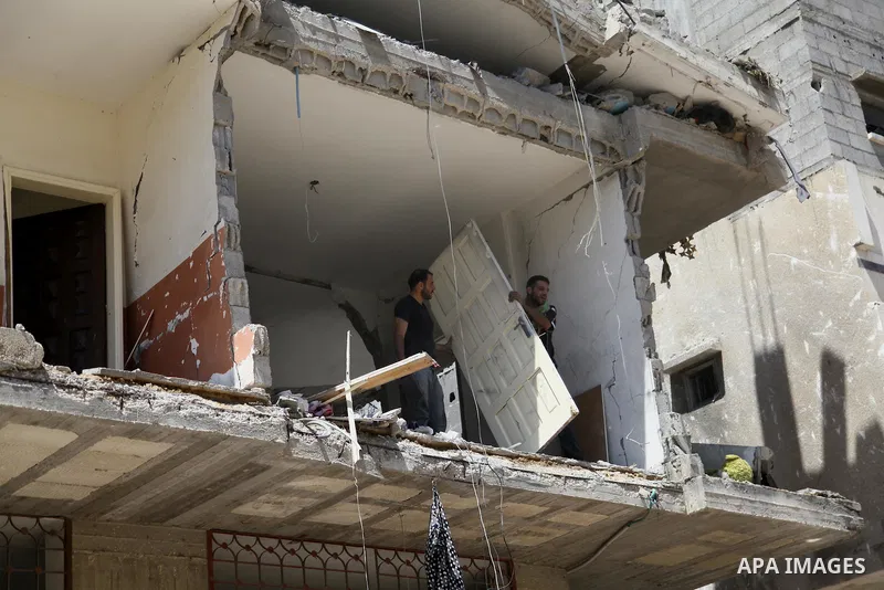 Palestinians inspect a house targeted in an Israeli air strike in Gaza city on August 25, 2014. Israel's Prime Minister Benjamin Netanyahu warned Palestinian civilians on Sunday to leave immediately any site where milita...