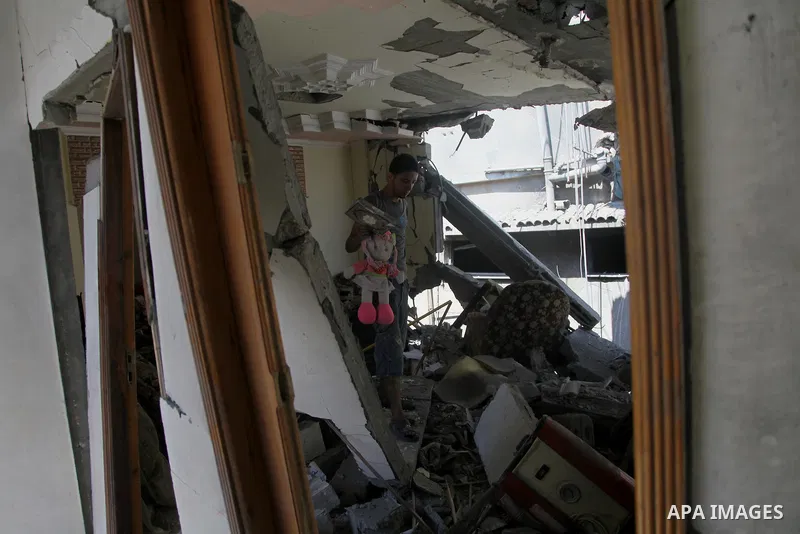 A Palestinian man inspects a house targeted in an Israeli air strike in Gaza city on August 25, 2014. Israel's Prime Minister Benjamin Netanyahu warned Palestinian civilians on Sunday to leave immediately any site where...