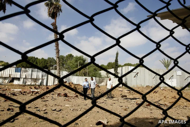 A member of the Palestinian security forces inspects the damage from an Israeli air strike at the Rafah border crossing with Egypt in the southern Gaza Strip on August 25, 2014. Violence reverberated across Gaza with fou...