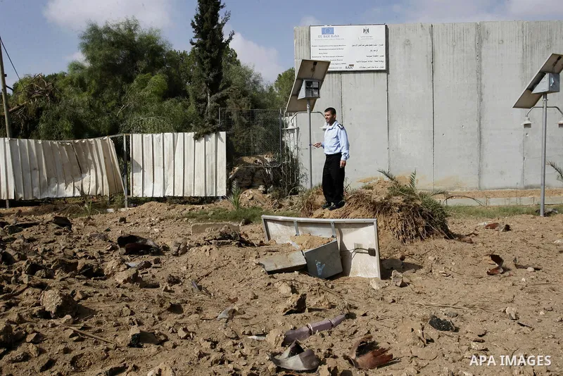 A member of the Palestinian security forces inspects the damage from an Israeli air strike at the Rafah border crossing with Egypt in the southern Gaza Strip on August 25, 2014. Violence reverberated across Gaza with fou...