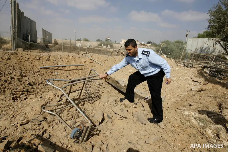 A member of the Palestinian security forces inspects the damage from an Israeli air strike at the Rafah border crossing with Egypt in the southern Gaza Strip on August 25, 2014. Violence reverberated across Gaza with fou...