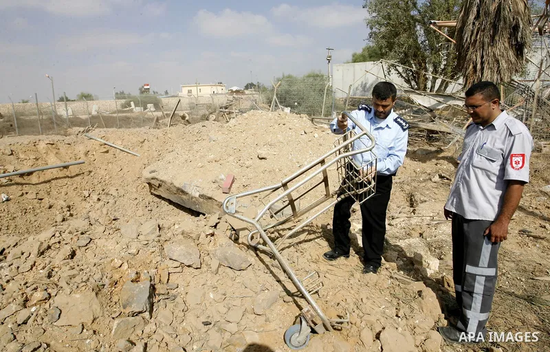 A member of the Palestinian security forces inspects the damage from an Israeli air strike at the Rafah border crossing with Egypt in the southern Gaza Strip on August 25, 2014. Violence reverberated across Gaza with fou...