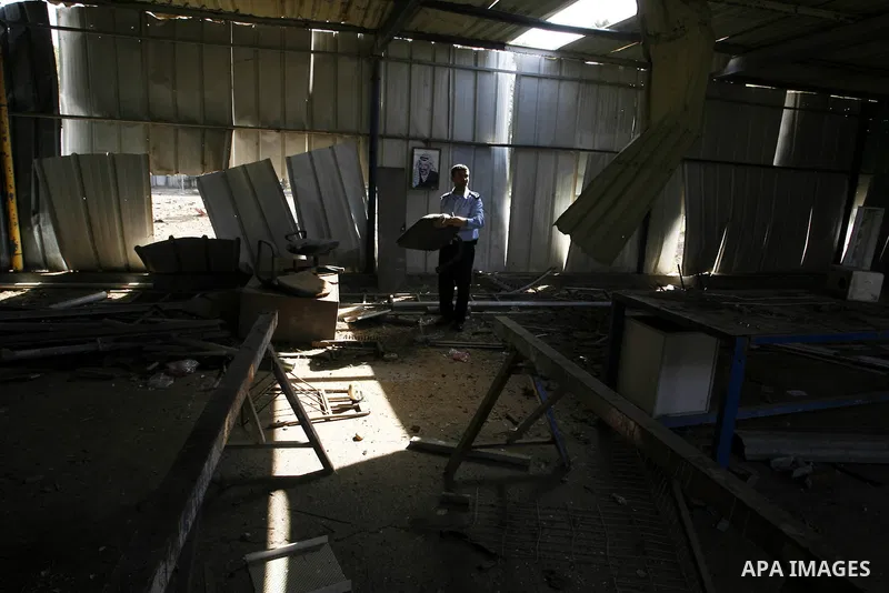 A member of the Palestinian security forces inspects the damage from an Israeli air strike to the departure lounge of the Rafah border crossing with Egypt in the southern Gaza Strip on August 25, 2014. Violence reverbera...