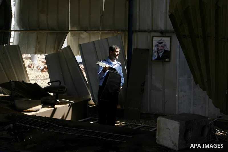 A member of the Palestinian security forces inspects the damage from an Israeli air strike to the departure lounge of the Rafah border crossing with Egypt in the southern Gaza Strip on August 25, 2014. Violence reverbera...