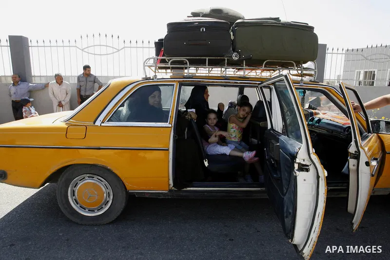 Palestinian travellers wait before crossing into Egypt at the Rafah border crossing with Egypt in the southern Gaza Strip on August 25, 2014. Violence reverberated across Gaza with four Palestinians killed in Israeli air...