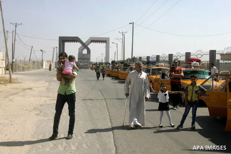 Palestinian travellers wait before crossing into Egypt at the Rafah border crossing with Egypt in the southern Gaza Strip on August 25, 2014. Violence reverberated across Gaza with four Palestinians killed in Israeli air...