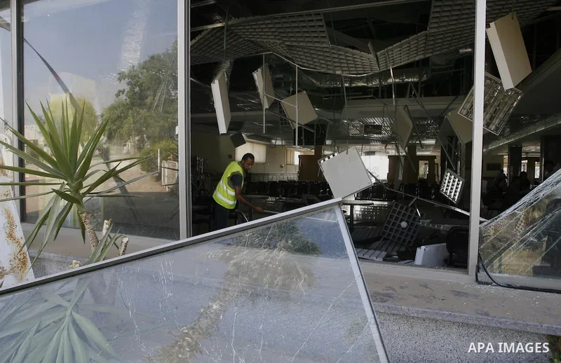 A Palestinian inspects the damage from an Israeli air strike to the departure lounge of the Rafah border crossing with Egypt in the southern Gaza Strip on August 25, 2014. Violence reverberated across Gaza with four Pale...