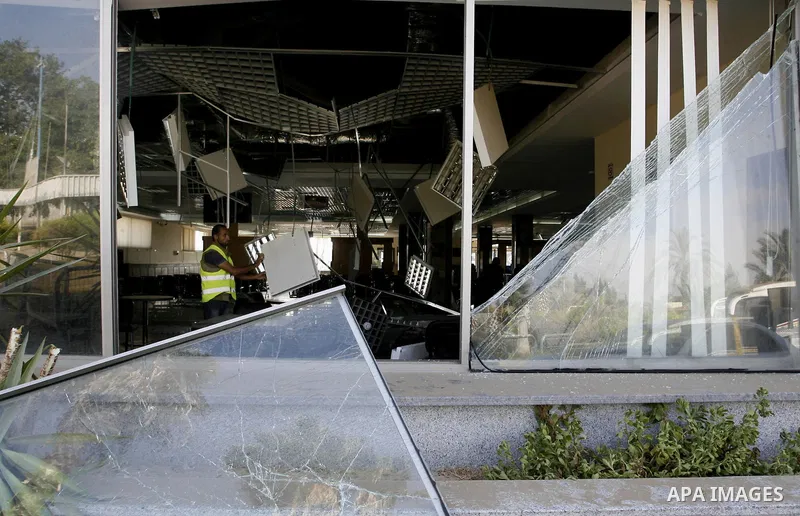 A Palestinian inspects the damage from an Israeli air strike to the departure lounge of the Rafah border crossing with Egypt in the southern Gaza Strip on August 25, 2014. Violence reverberated across Gaza with four Pale...