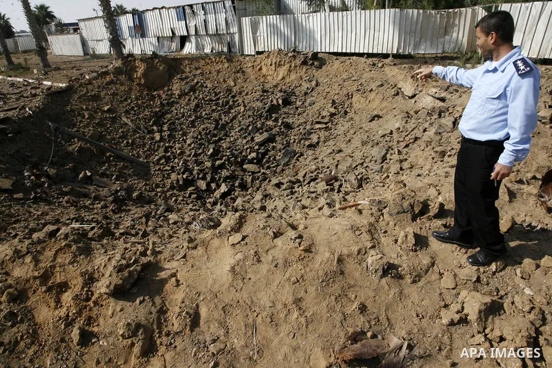 A member of the Palestinian security forces inspects the damage from an Israeli air strike at the Rafah border crossing with Egypt in the southern Gaza Strip on August 25, 2014. Violence reverberated across Gaza with fou...